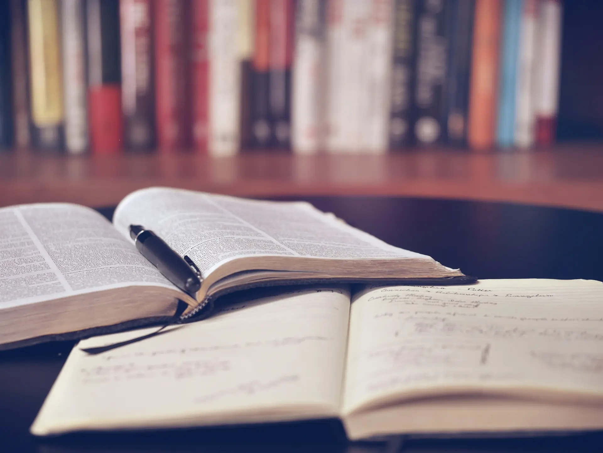 Open notebook on a wooden desk, suggesting editorial writing
