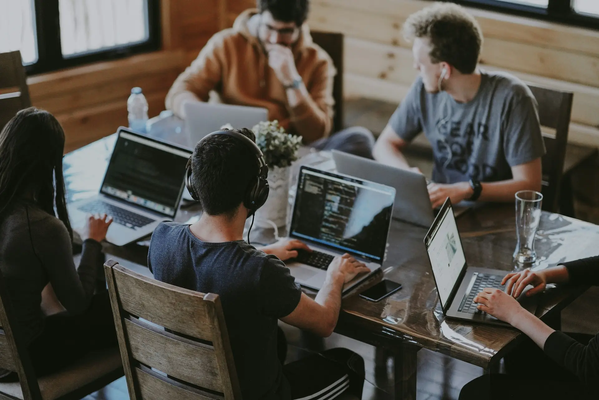 Small team collaborating around a laptop