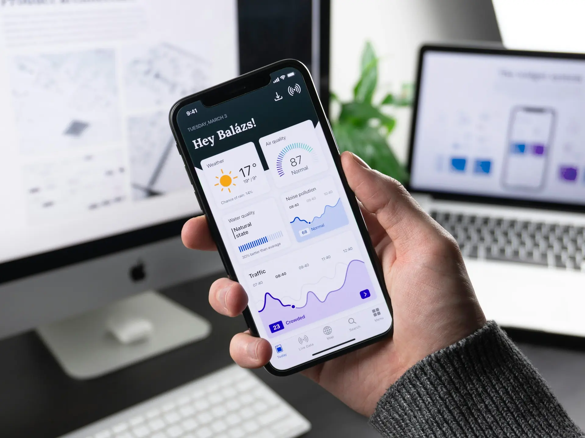 Mobile app design mockups on a desk