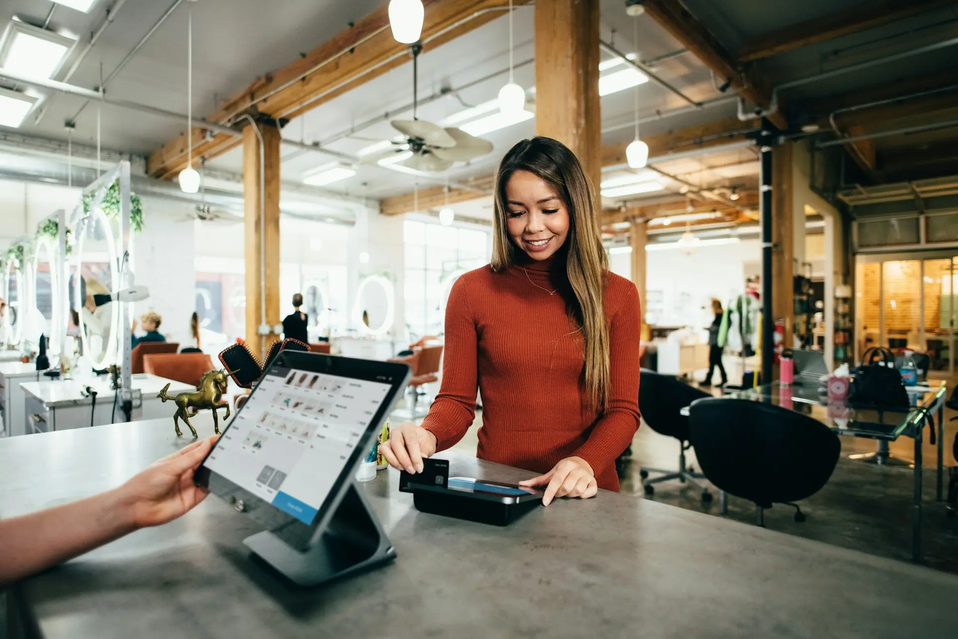 Modern POS terminal in a busy retail store