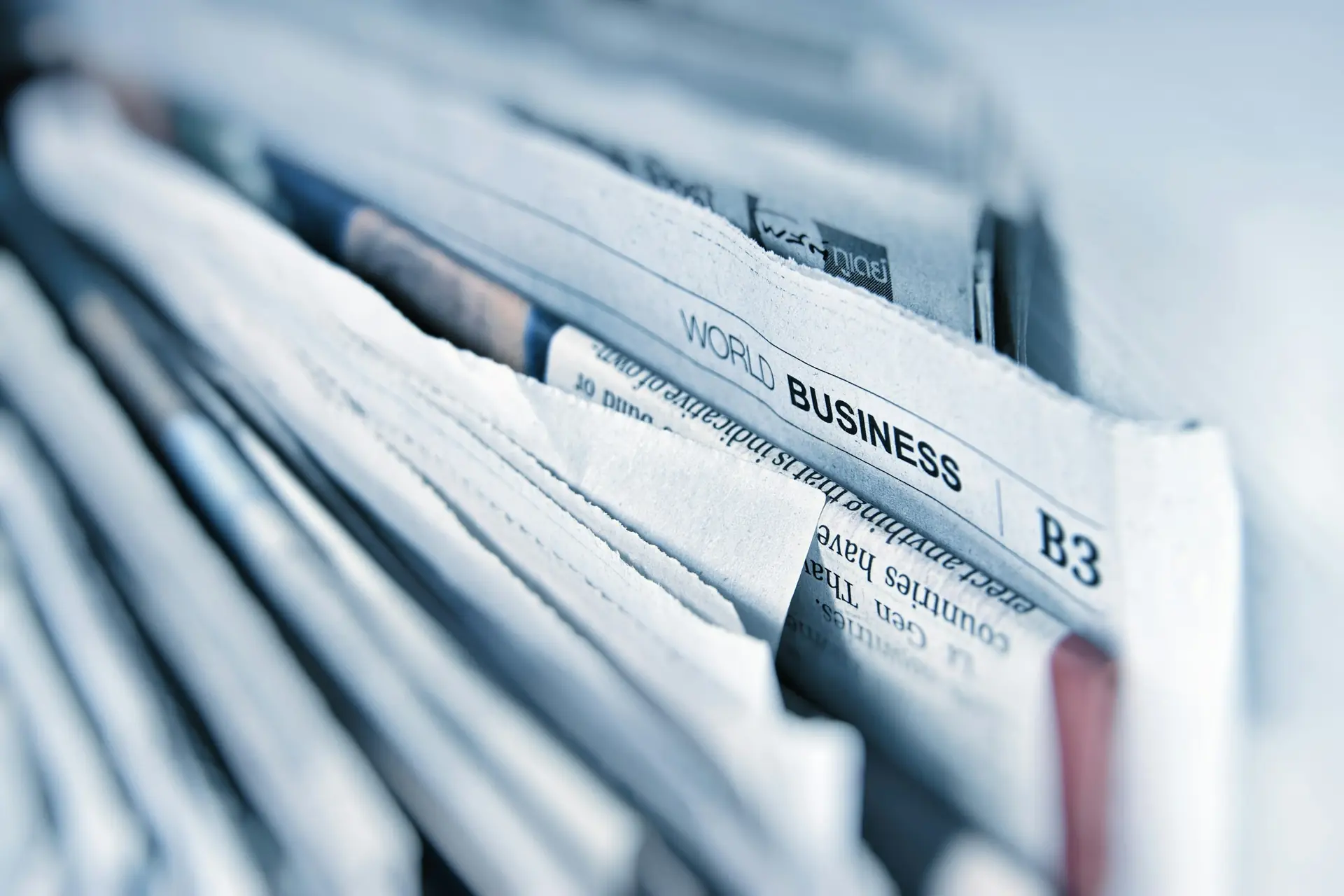 Stack of newspapers, suggesting press and announcements