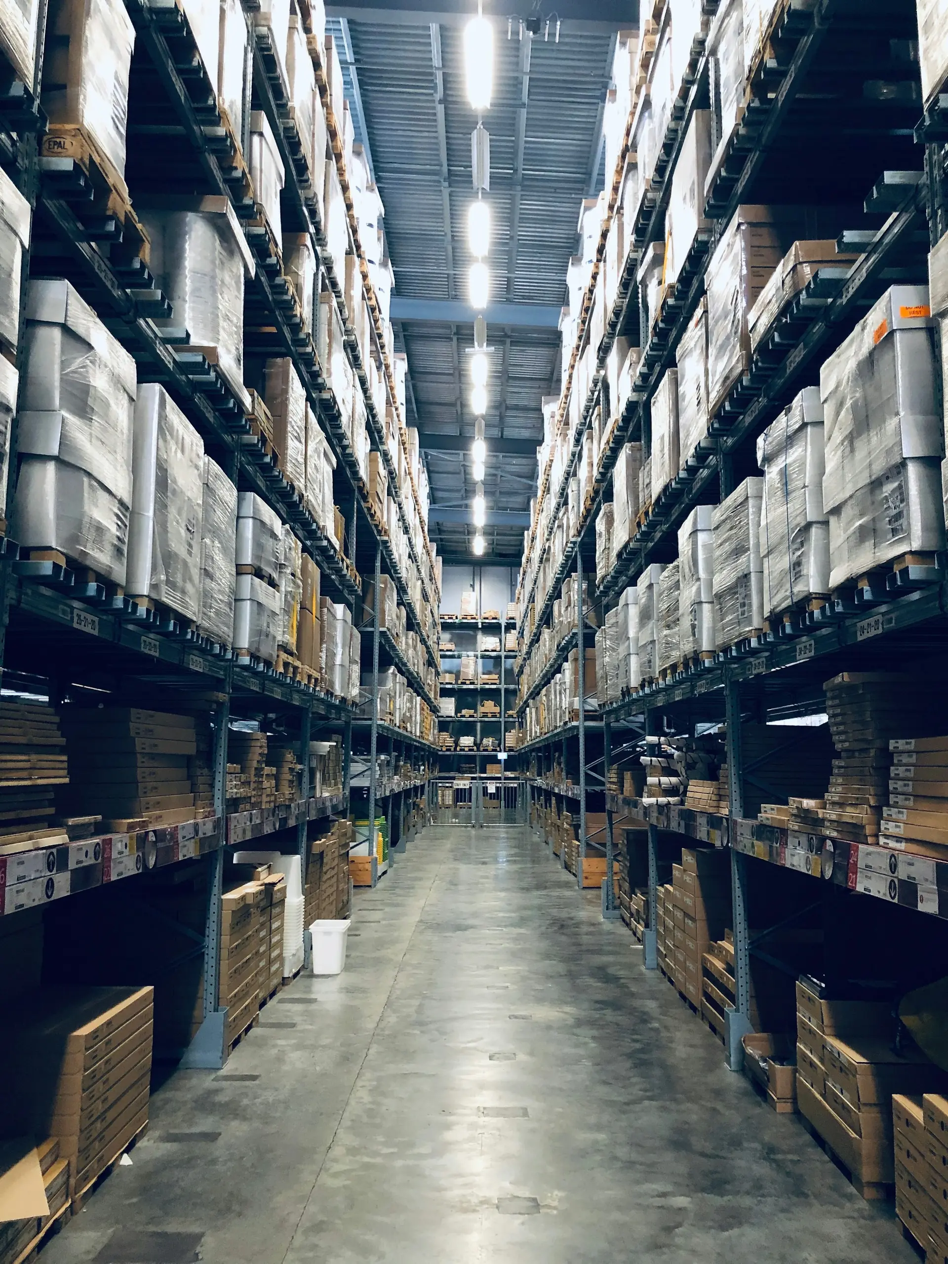 Warehouse worker scanning a package with a mobile phone